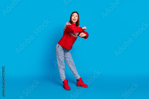 Full length body size photo woman in red sweater dancing at party looking copyspace isolated vivid blue color background