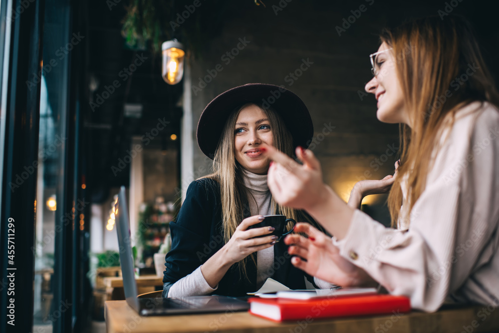 Smiling women discussing at table of bar Smiling women discussing at table of bar