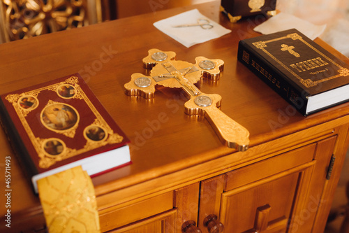 Fototapet Prayer books with cross and scissors for the baptismal ceremony