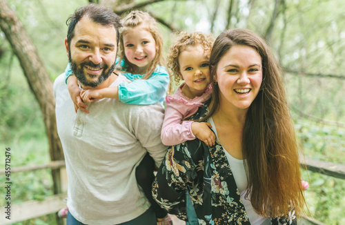 nice family having fun in summer forest