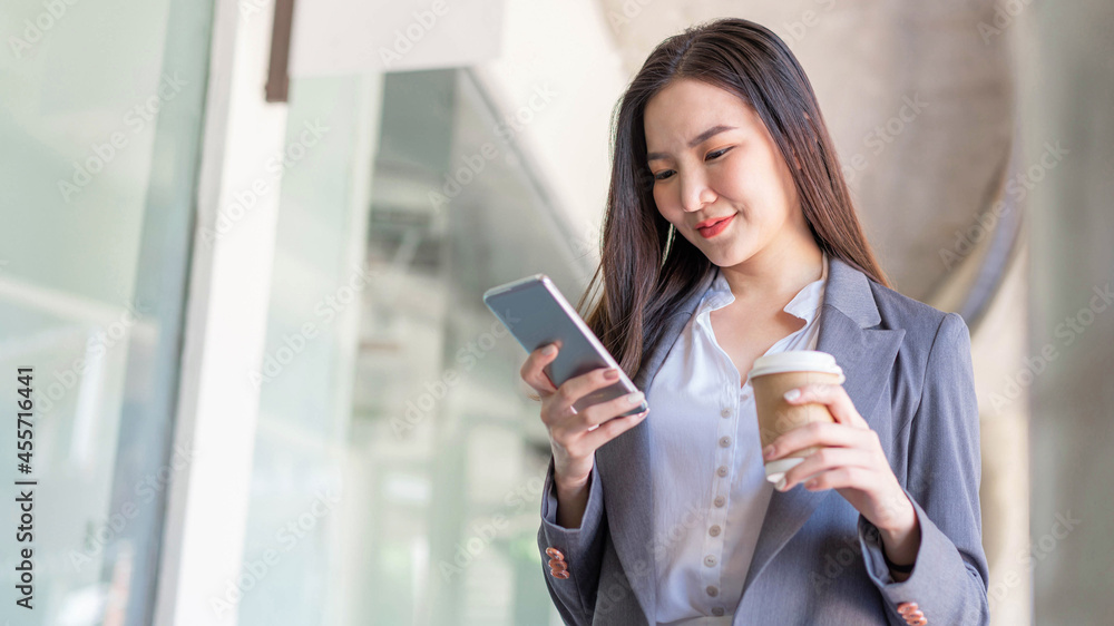 Working woman concept a young female manager attending video conference and holding a cup of coffee