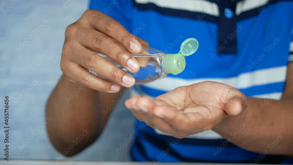 young man pouring hair oil on hand young man pouring hair oil on hand