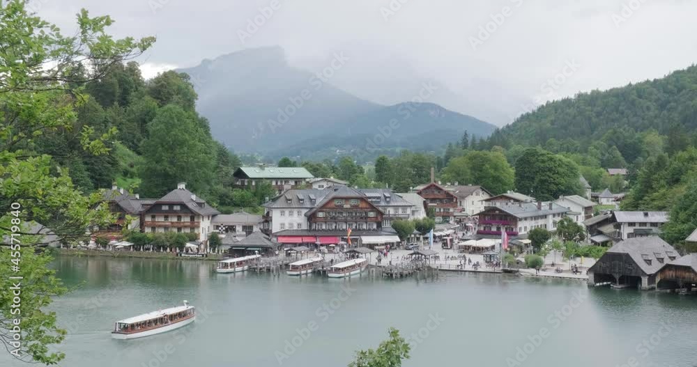 Boat arrives at Konigssee pier, a popular, touristic location in Bavaria, Germany. Overcast day, tourism. Boat arrives at Konigssee pier, a popular, touristic location in Bavaria, Germany. Overcast day, tourism.