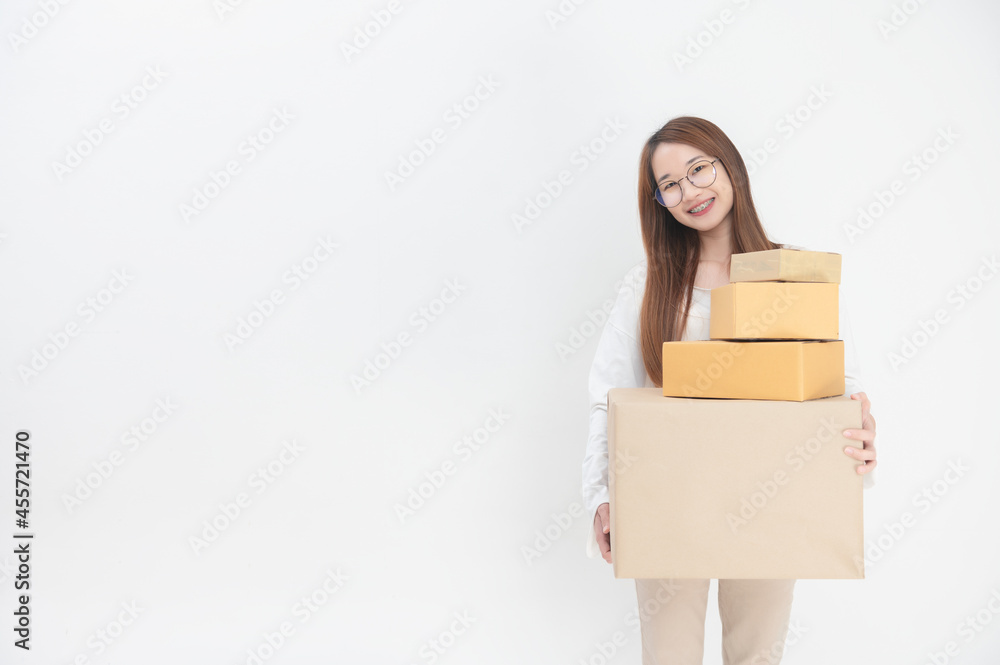 Happy Asian youngwoman holding package parcel box at home, Delivery courier and shipment service concept Happy Asian youngwoman holding package parcel box at home, Delivery courier and shipment service concept