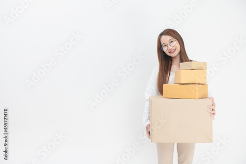 Happy Asian youngwoman holding package parcel box at home, Delivery courier and shipment service concept