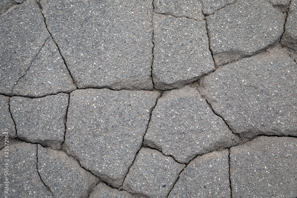 Obraz premium Cracked asphalt into small pieces. Decorative background