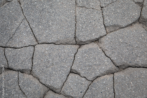 Cracked asphalt into small pieces. Decorative background