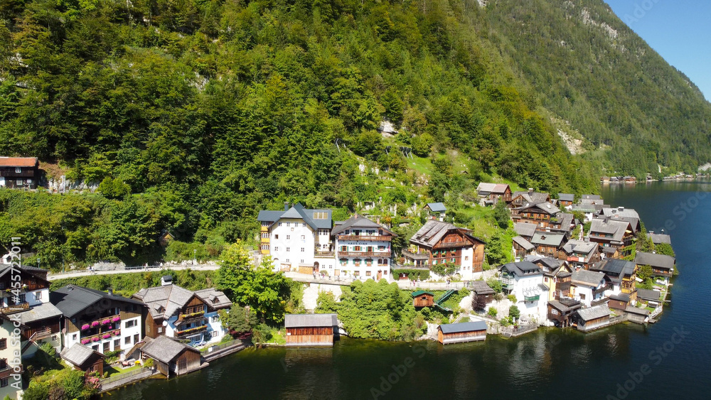 Hallstatt, Austria. Aerial view of the beautiful town from a flying drone over the lake in summer season. Hallstatt, Austria. Aerial view of the beautiful town from a flying drone over the lake in summer season.