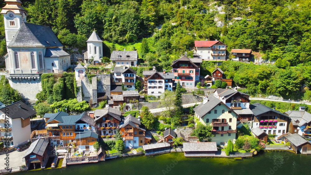 Obraz premium Hallstatt, Austria. Aerial view of the beautiful town from a flying drone over the lake in summer season.