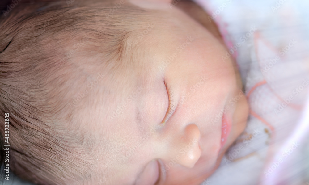 Newborn baby girl on the crib in the first days of life. Concept of life and happiness Newborn baby girl on the crib in the first days of life. Concept of life and happiness