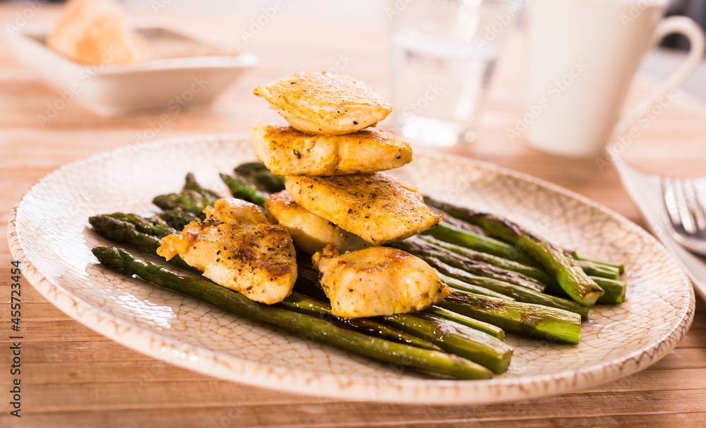 cooked dish. Chicken nuggets with green asparagus on plate cooked dish. Chicken nuggets with green asparagus on plate