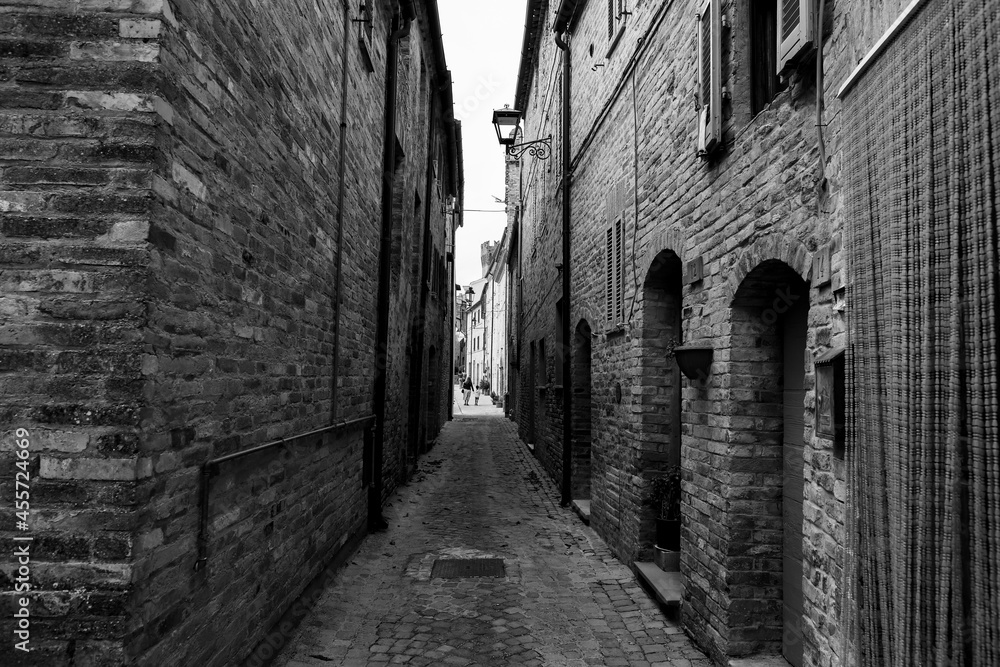 Glimpse of a small medieval village in the province of Fermo, in the background the Marche countryside, very cloudy sky, black and white photo. Glimpse of a small medieval village in the province of Fermo, in the background the Marche countryside, very cloudy sky, black and white photo.