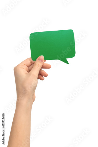 Blank green speech bubble in female hand, isolated on a white background. Text message, giving feedback concept photo