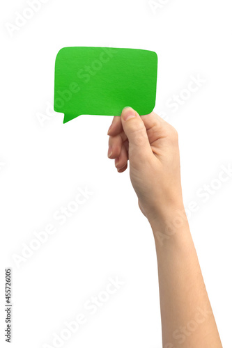 Blank green speech bubble in female hand, isolated on a white background