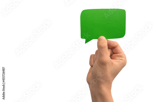 Hand holding a green blank speech bubble over white background