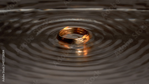 Gold ring with a pattern in a dark dialect photo