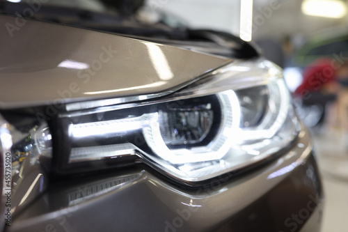 View of modern silver car xenon headlight bulb closeup