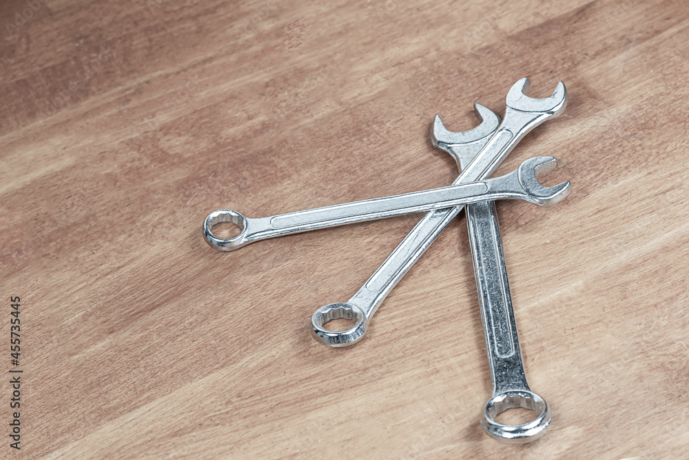 set of silver metal wrenches on the master's workbench set of silver metal wrenches on the master's workbench