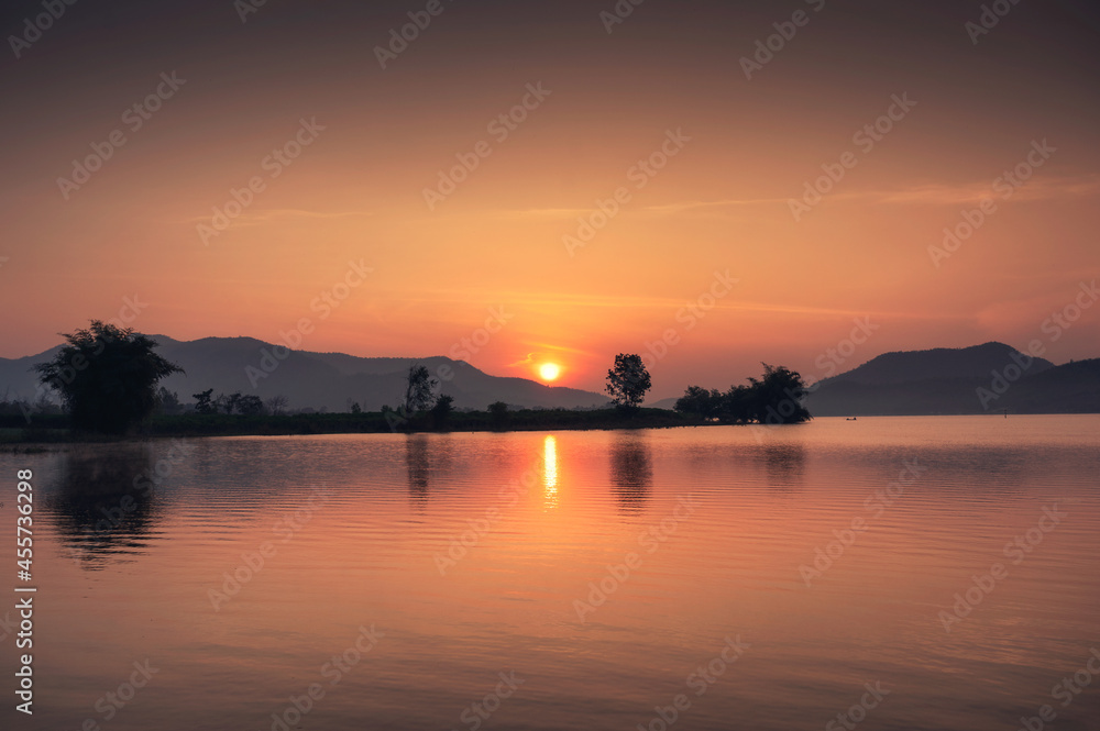 Sunrise over mountain range on Lam Taphoen reservoir in countryside