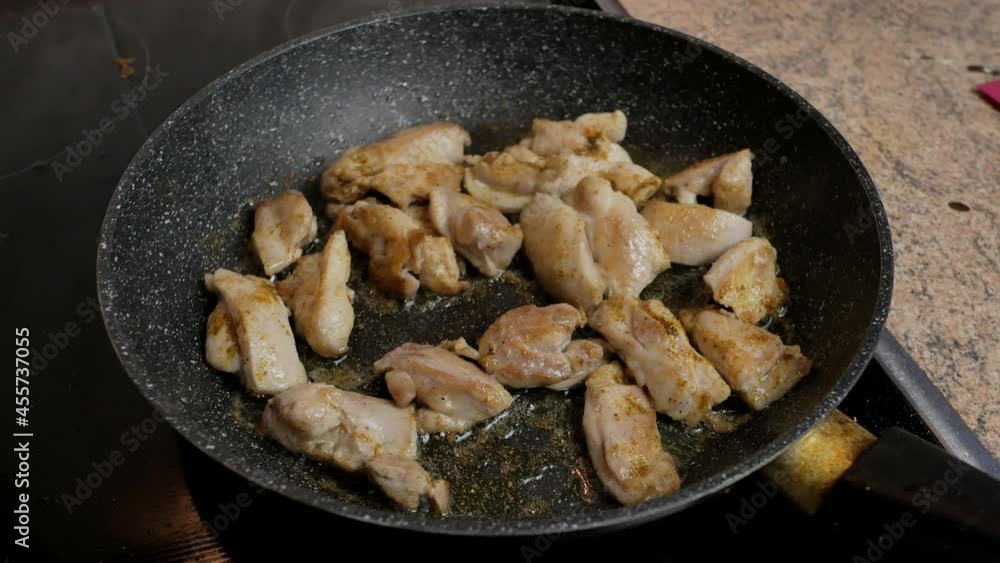 fry the chicken meat in a frying pan in the kitchen fry the chicken meat in a frying pan in the kitchen