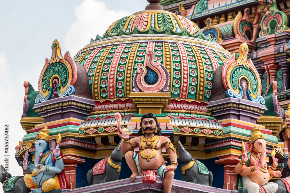 Fototapeta premium A colorfully decorated tower with mythological figures and deities in an ancient Hindu temple in Tamil Nadu.