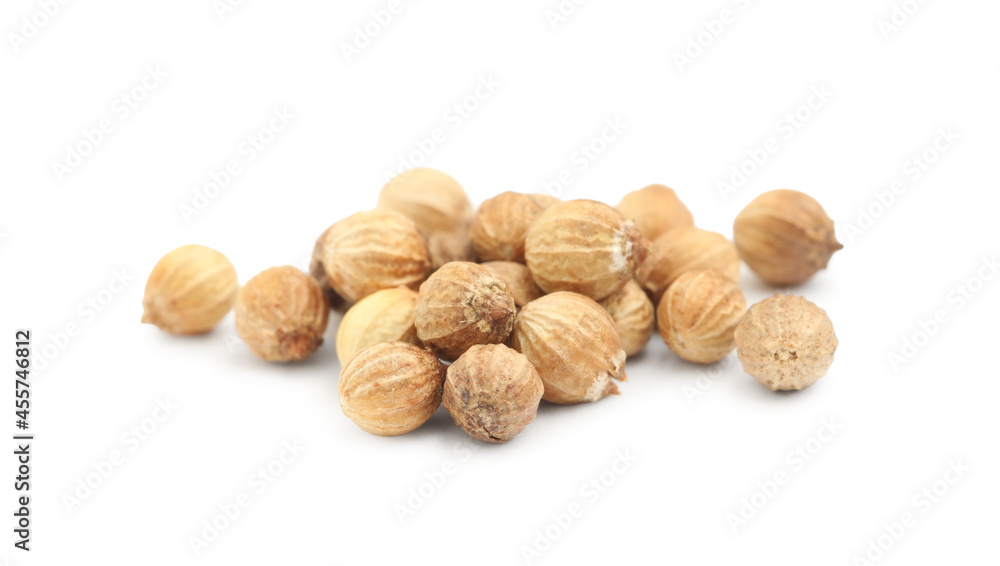 Scattered dried coriander seeds on white background, closeup Scattered dried coriander seeds on white background, closeup