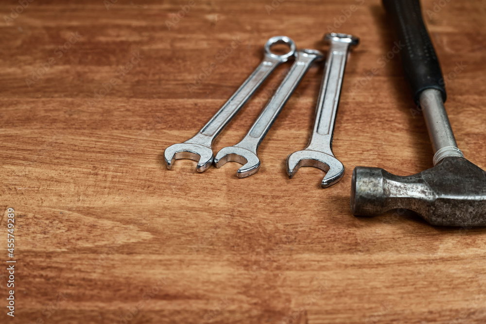 wrench and hammer machine repair tool on wooden background wrench and hammer machine repair tool on wooden background