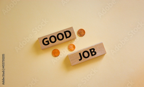 Good job symbol. Concept words 'good job' on wooden blocks on a beautiful white background, metallic coins. Business and good job concept, copy space.