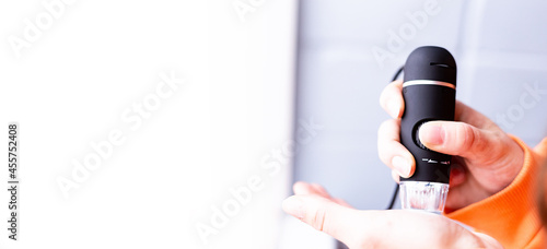 a portable computer and a microscope. computer microscope, manual microscope. Science, the future, forensic laboratory, research, distance education, online learning, home learning concept