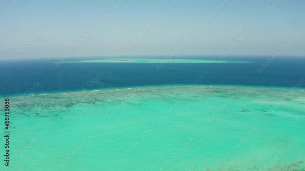 Atoll with coral reef and small lagoon, blue water of the sea, aerial view. Balabac, Palawan, Philippines. Summer and travel vacation concept. Atoll with coral reef and small lagoon, blue water of the sea, aerial view. Balabac, Palawan, Philippines. Summer and travel vacation concept.
