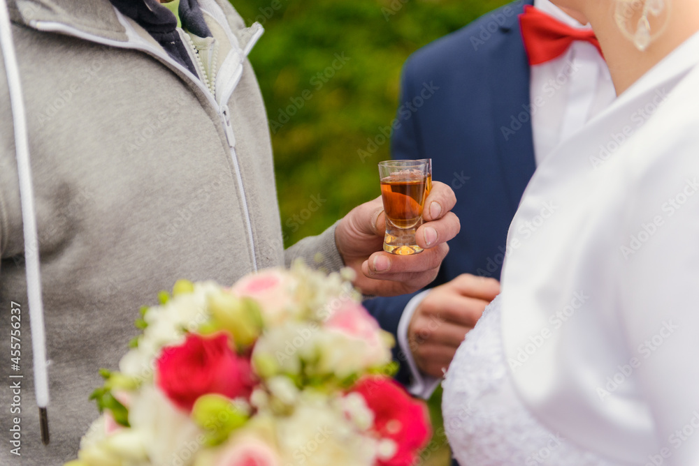 Couple toasting cocktails at wedding party. Bride and groom