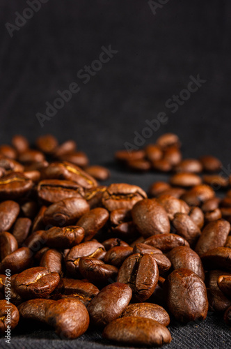 Natural background for Cafe menu or brochure template - macro photo of brown roasted coffee beans  close up