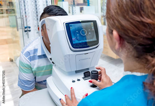 .Modern medicine contributes to the care of eyesight. Female ophthalmologist makes medical diagnosis of a young patient