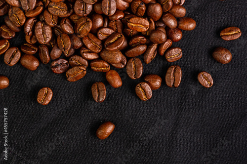 Natural background for Cafe menu or brochure template - macro photo of brown roasted coffee beans, close up