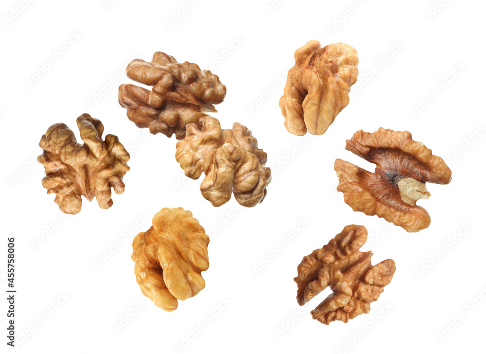 Halves of walnuts falling on white background Halves of walnuts falling on white background