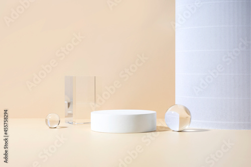 Cosmetic product showcase stand photography for online marketing include crystal ball and white stand on beige background