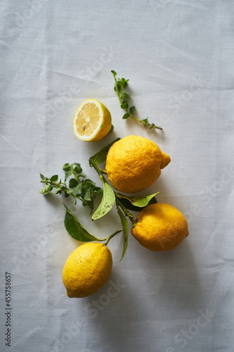 Ripe whole and cut lemons with herbs