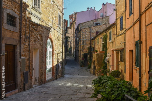 A narrow alley in the old village of Castagneto Carducci in the Maremma area of Tuscany with the typical stone houses  Italy