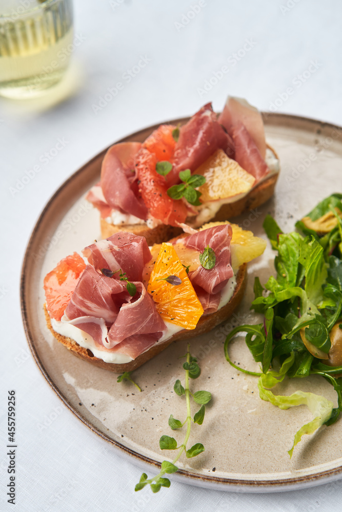 Bruschetta with citrus and ham and salad Bruschetta with citrus and ham and salad