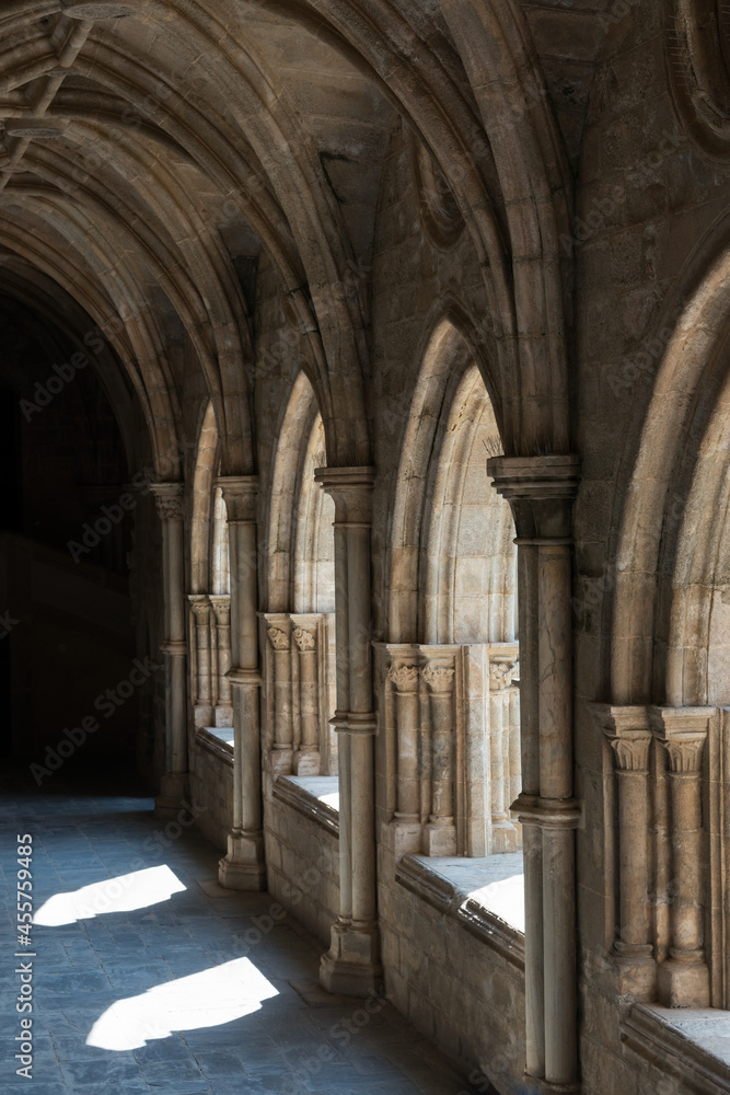 Beautiful cloister at Evora Cathedral. Stone arches, gothic style. Portugal, Europe