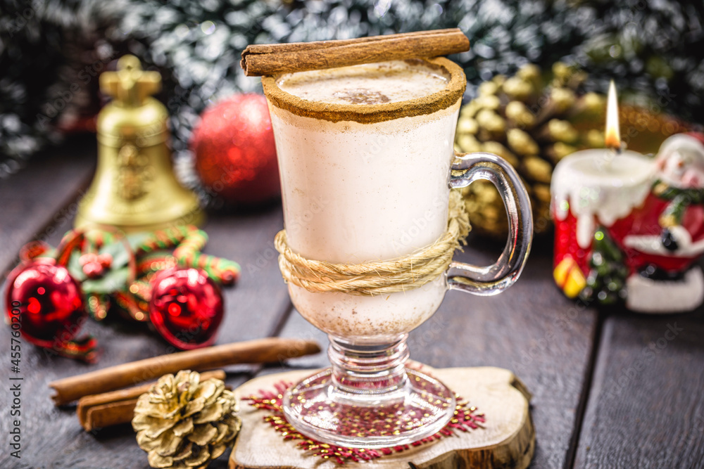 glass of hot eggnog, Christmas drink, based on eggs, cinnamon, almonds and rum liqueur. called eggnog