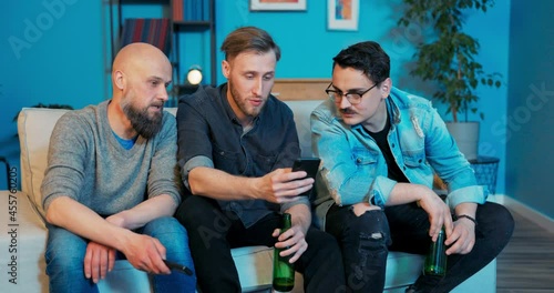 Guy shows friends new sales offer messages pictures on phone, he talking man drops his phone, he is angry, pissed off, picks it up, glass is broken, he doesn't care again, throws smartphone onground