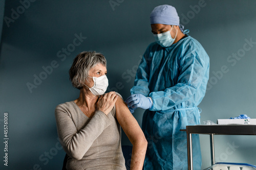 Nurse Puts a Bandage on a Senior Woman's Arm photo