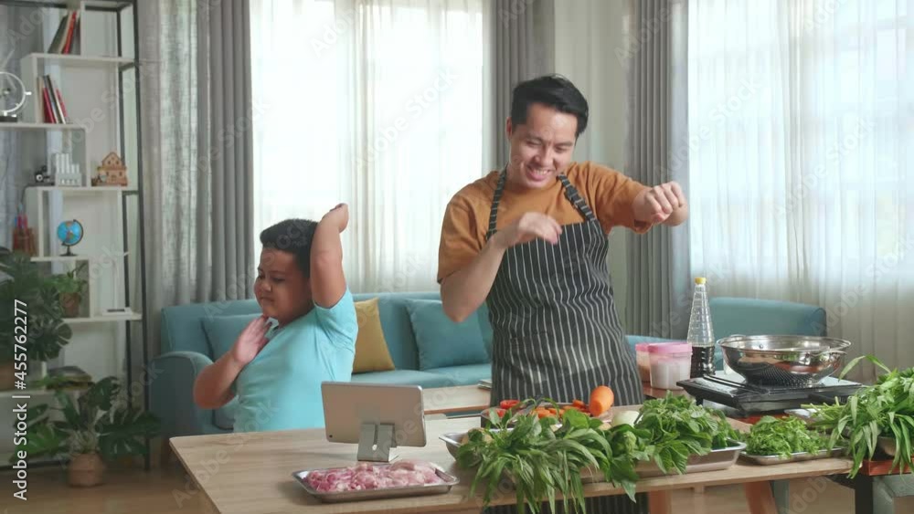 Funny Asian Man Father And Little Child Son Dancing Together While Cooking At Home
Funny Asian Man Father And Little Child Son Dancing Together While Cooking At Home
