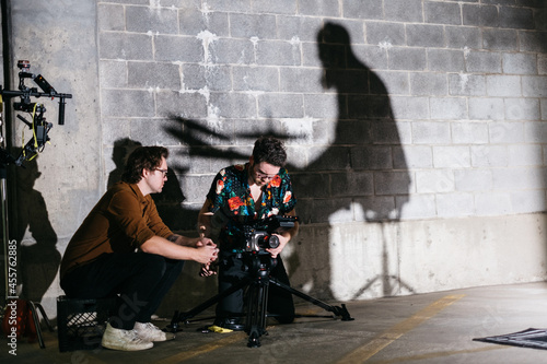 Cinematographer and director filming in a parking garage photo