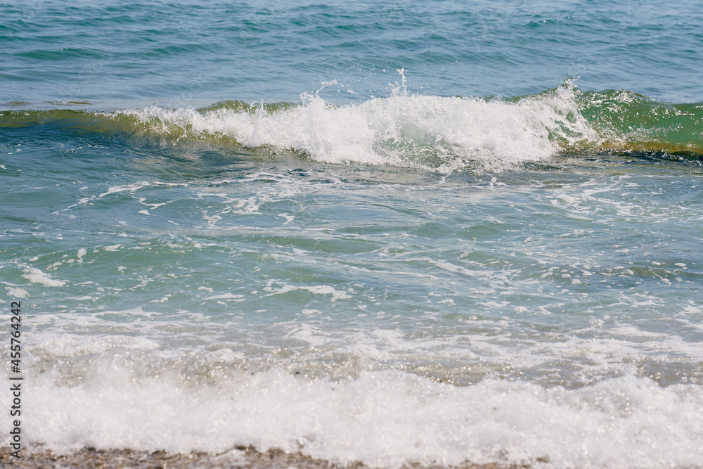 Fototapeta premium Waves with foam on Aegean sea coast in Crete Greece.