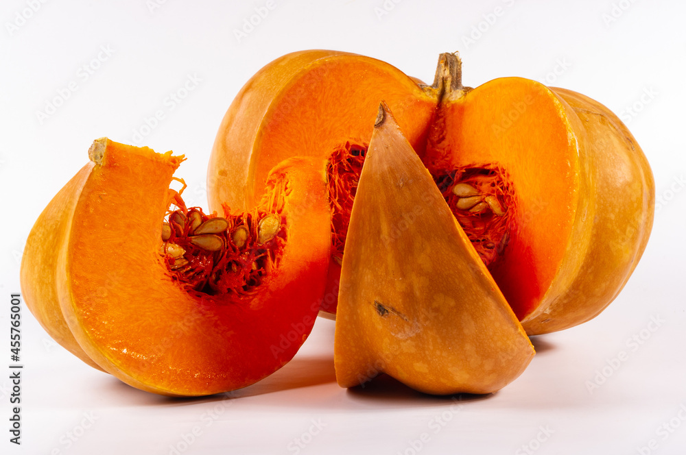 Cutted fresh orange big pumpkin on white background, close up. Organic agricultural product, ingredients for cooking, healthy food vegan. Cutted fresh orange big pumpkin on white background, close up. Organic agricultural product, ingredients for cooking, healthy food vegan.
