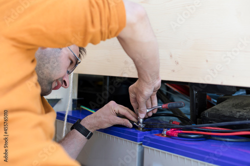 Man Working on Accumulator Battery Setup