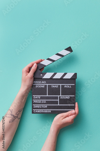 Woman holding clapper board