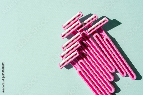 Disposable razors  a creative composition of disposable razors on a turquoise background